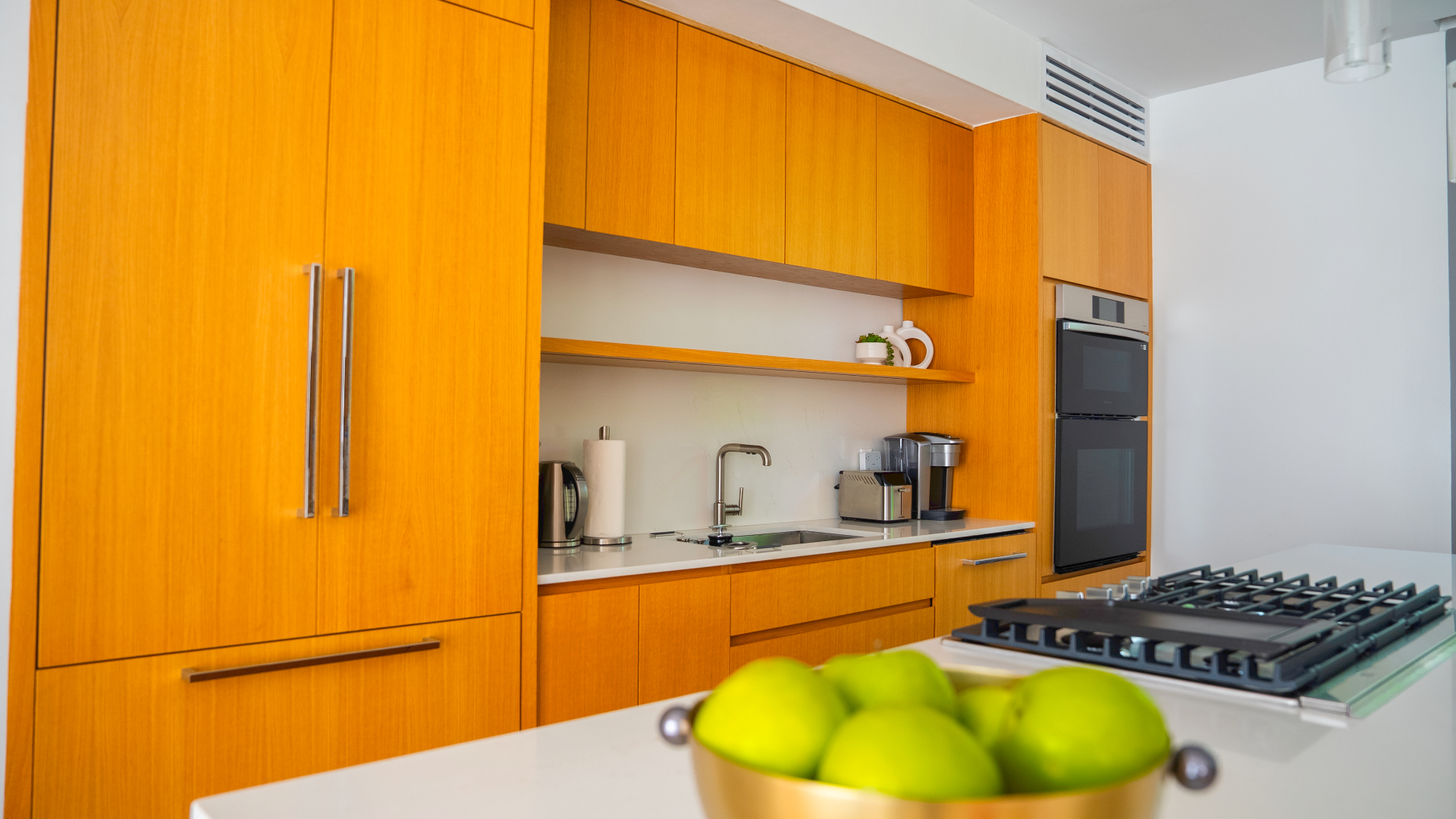 Villa Cyan kitchen with wood cabinetry and modern appliances