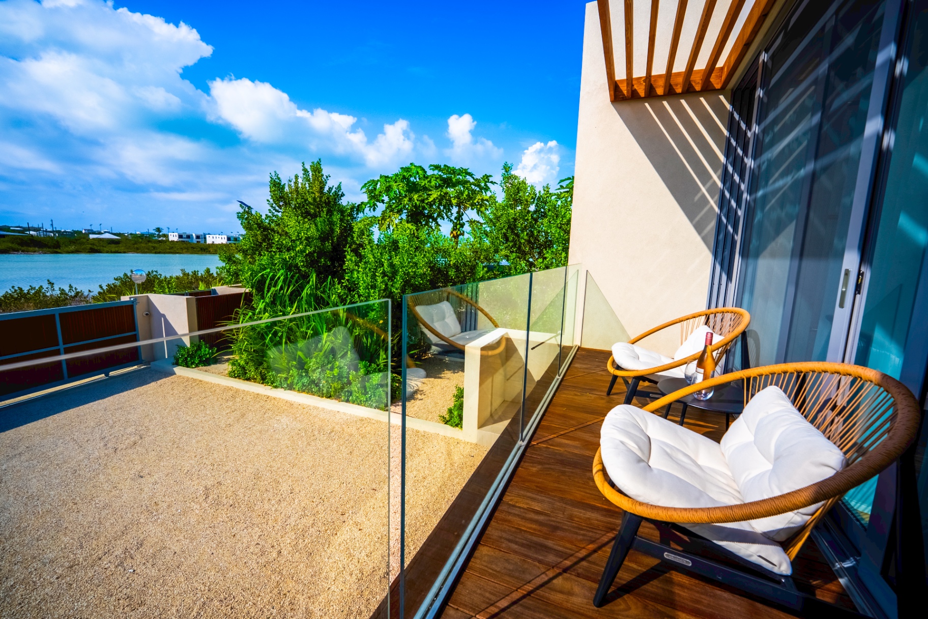 Private balcony seating overlooking the lake and tropical landscape