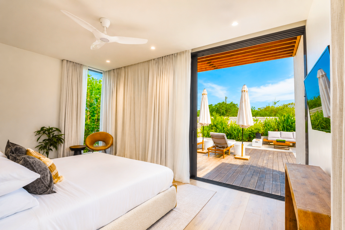 Second bedroom opening onto a private deck with sun loungers