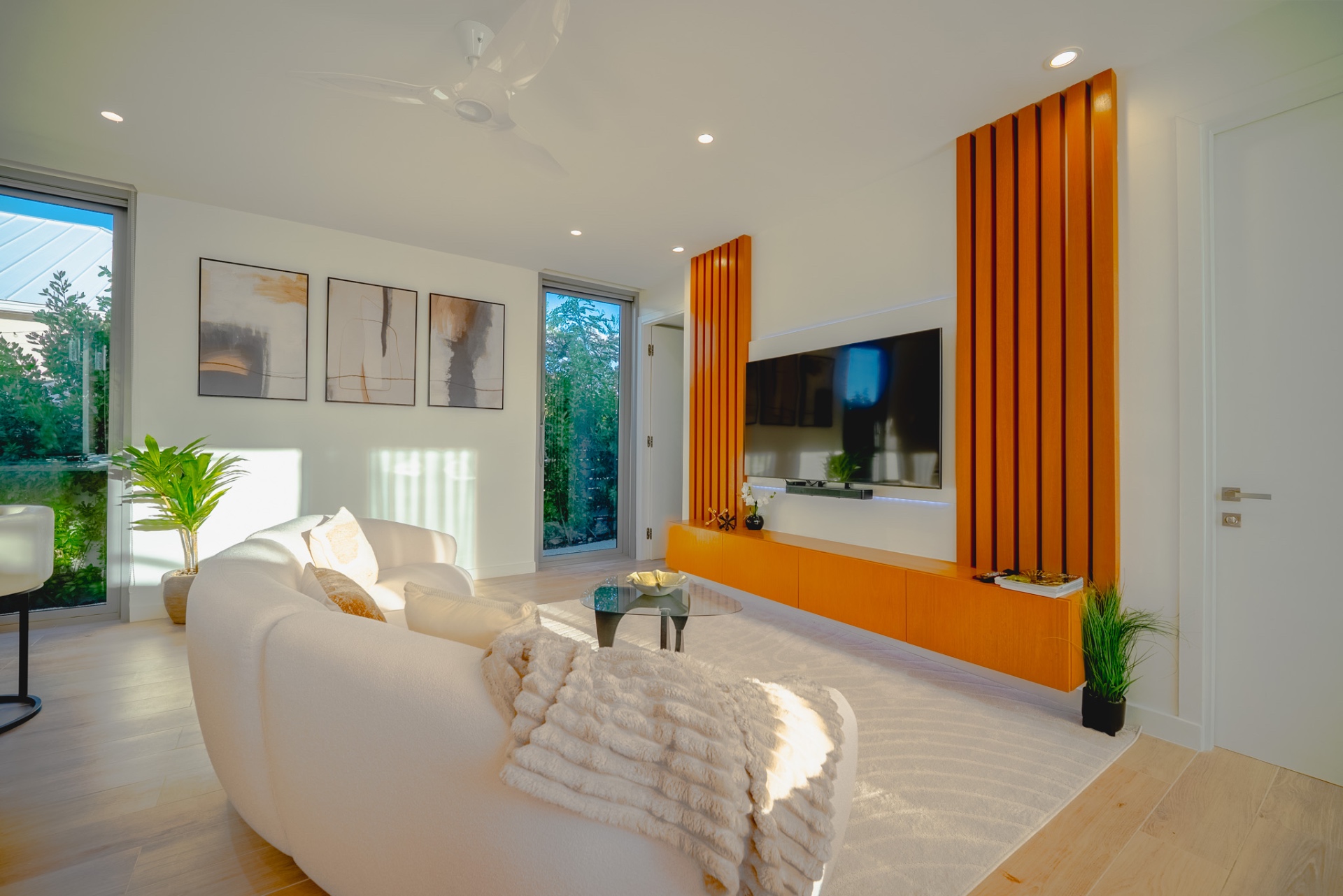 Sunlit living room with custom wood media wall