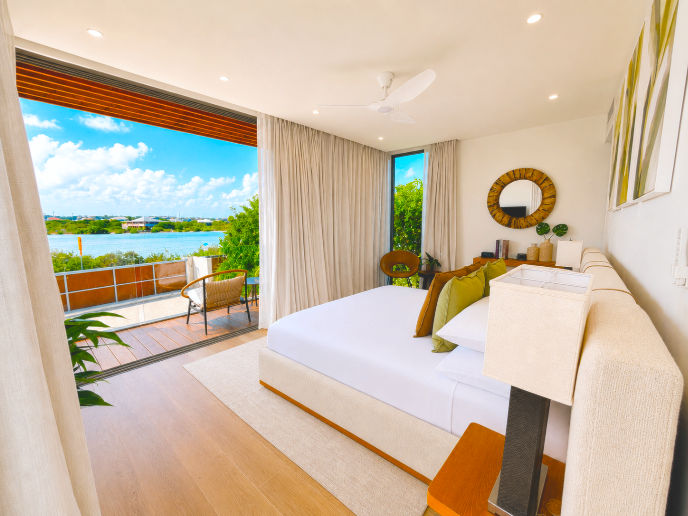 Bright bedroom with a water view and private outdoor seating