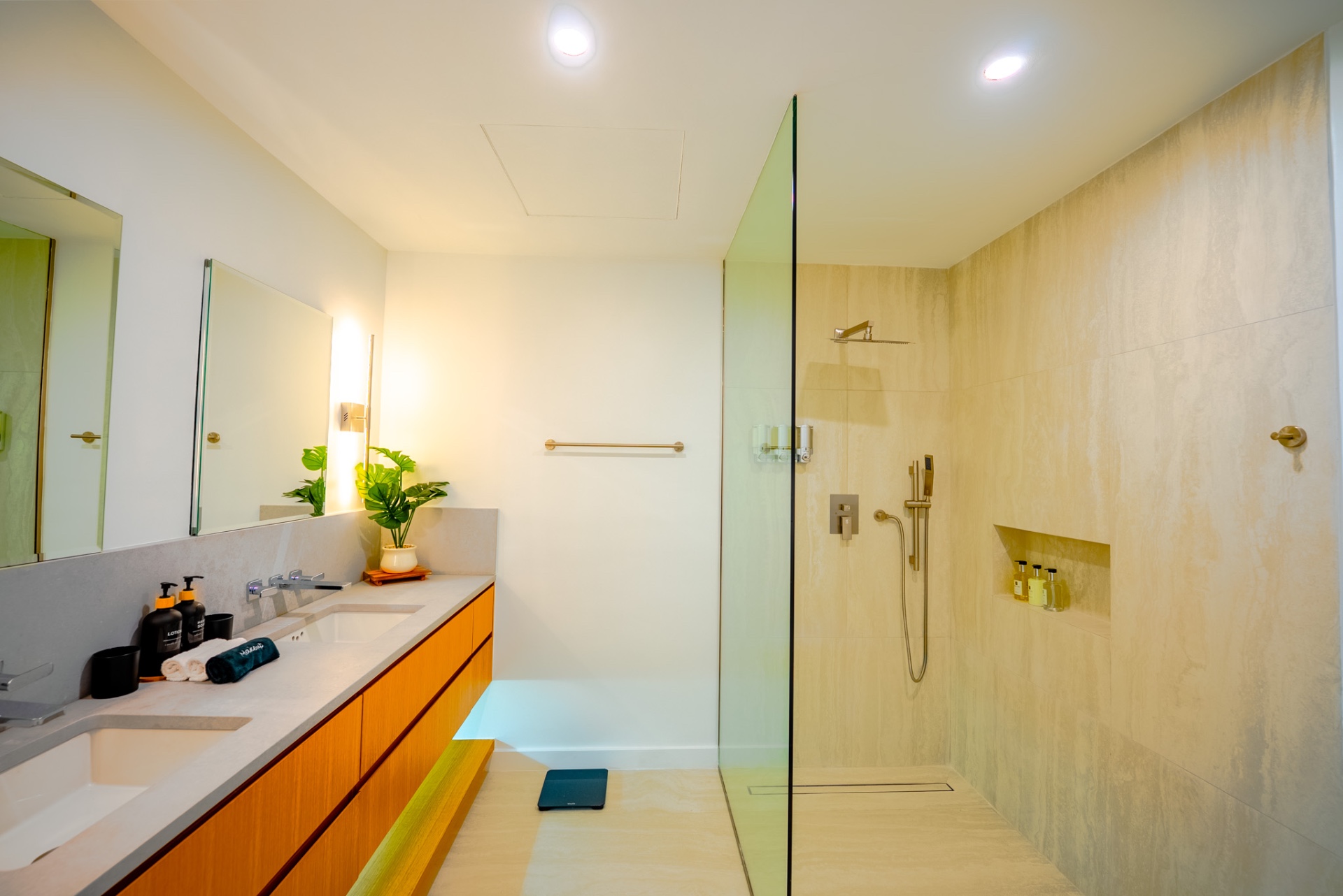 Spa-style bathroom with double vanity and walk-in rain shower