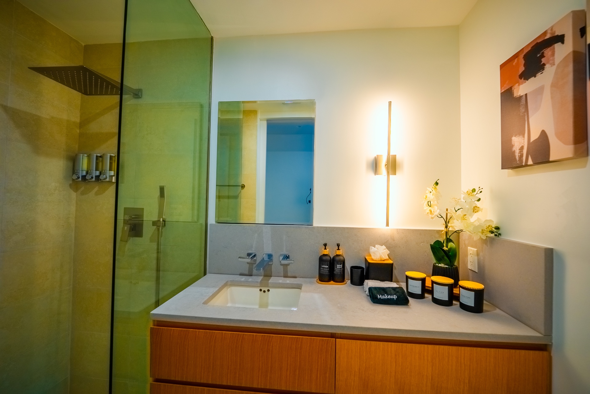 Second bathroom with linear sconce and travertine shower